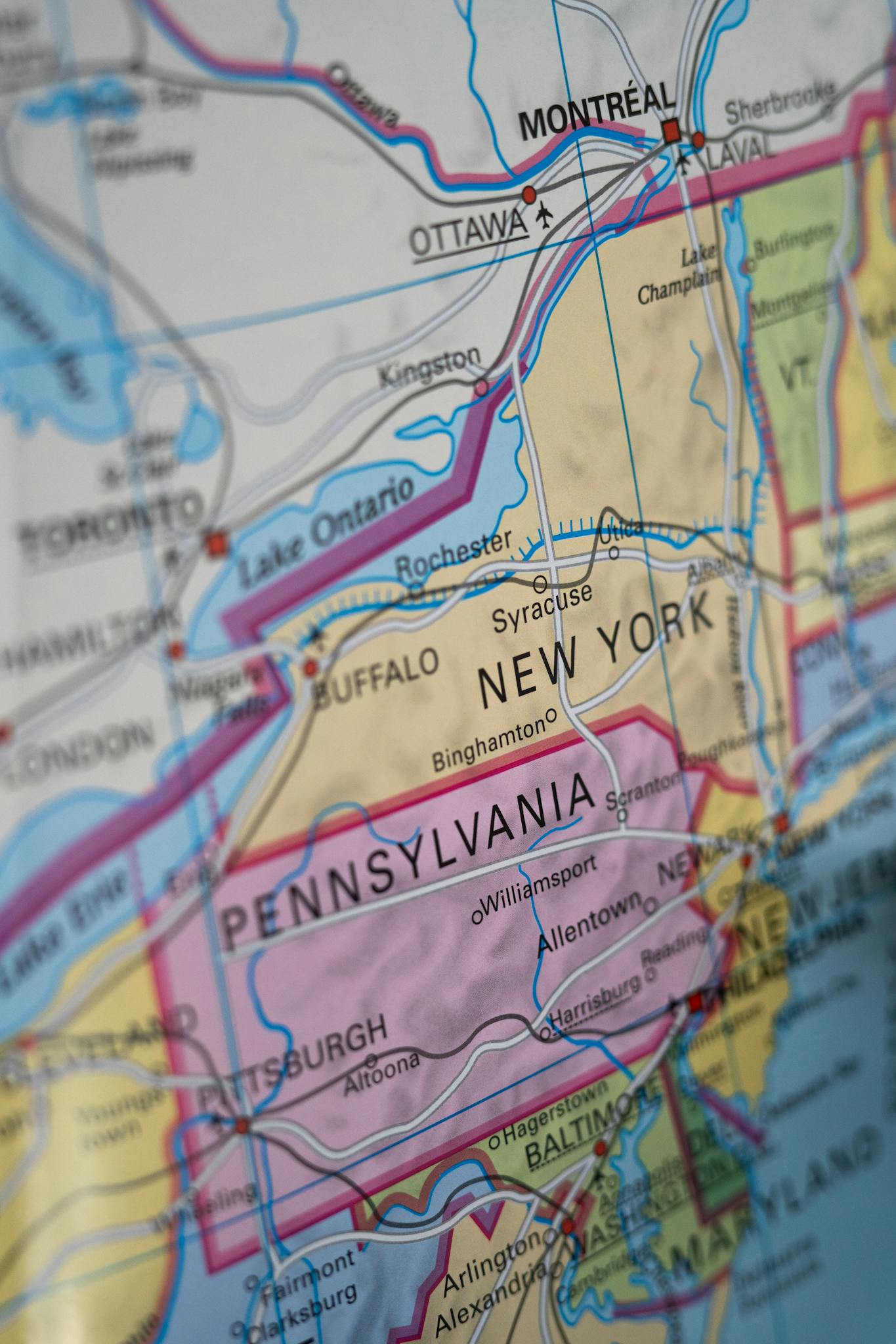 Close-up view of a paper map highlighting New York and Pennsylvania regions.